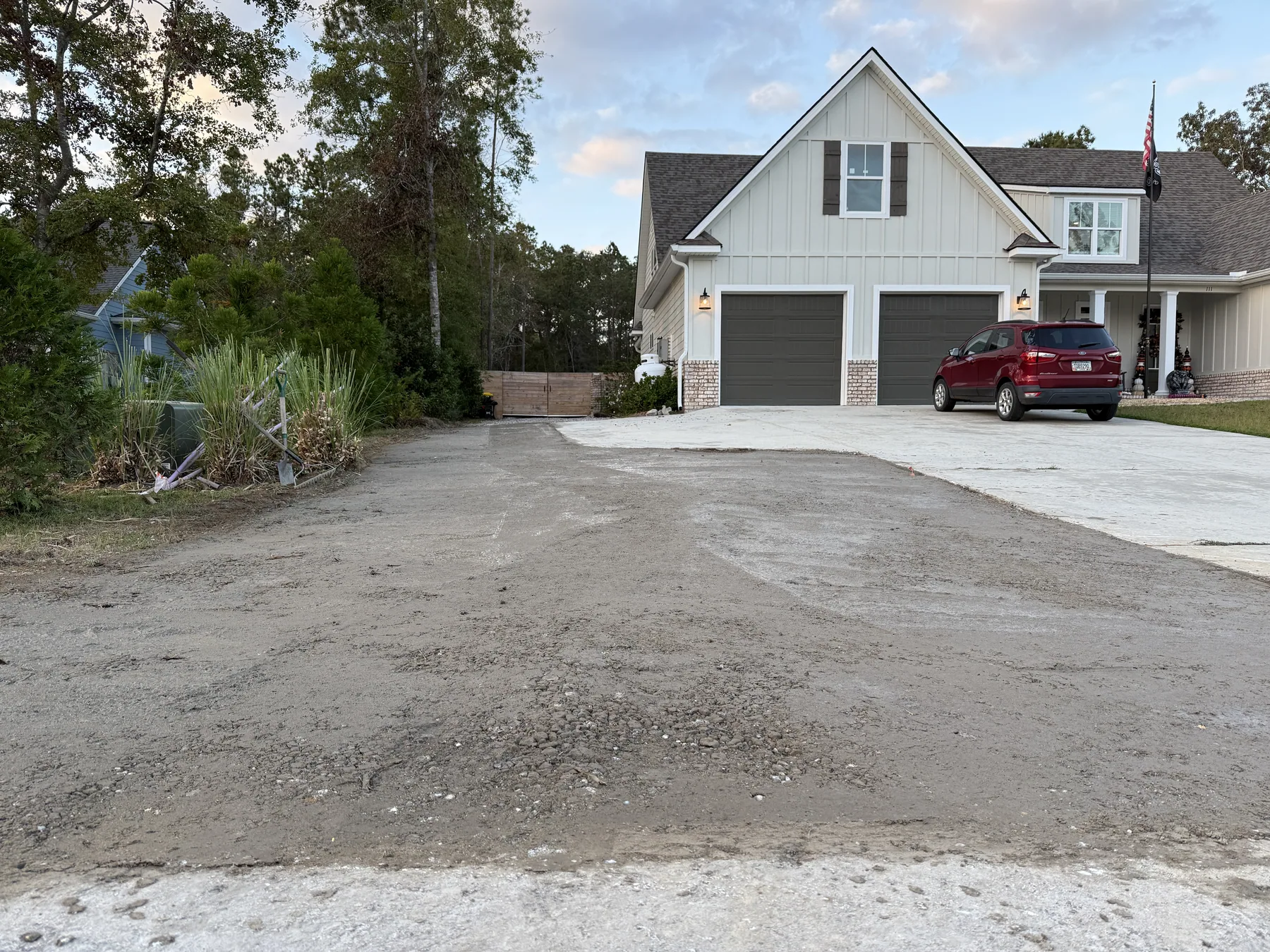 Newly cut driveway base running back into a wooded property